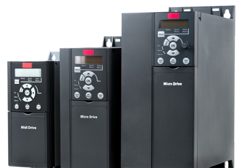 Set of black variable frequency drives (VFDs) labeled Micro Drive and Midi Drive, used for motor speed control in industrial applications.