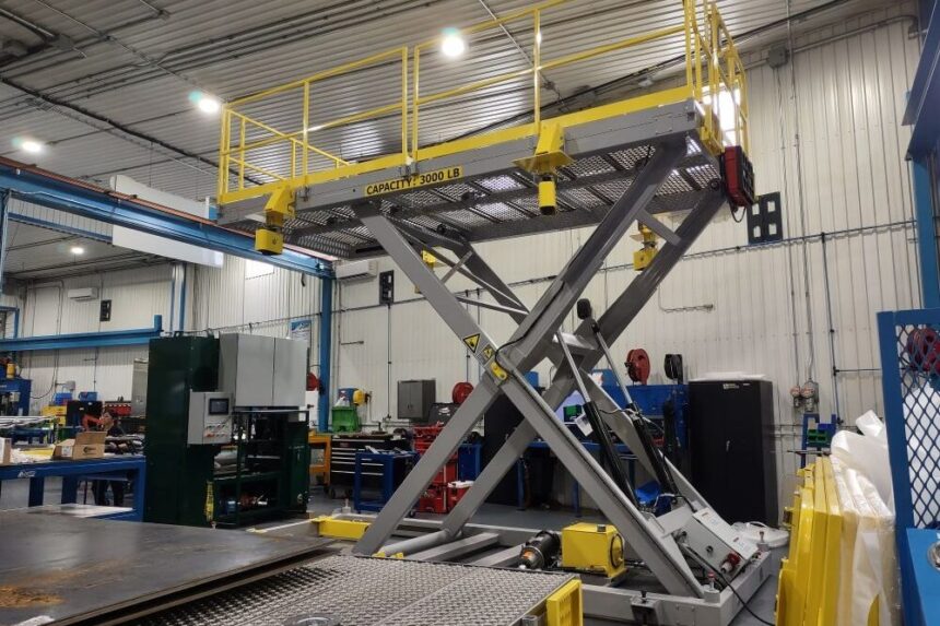 Heavy-duty scissor lift platform designed for industrial applications, with a 3000 lb capacity in a manufacturing workshop