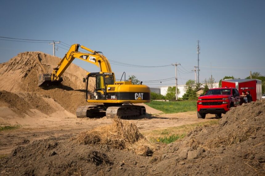 Excavator and mobile workshop truck on a construction site during on-site heavy machinery machining